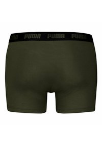 Boxer briefs da uomo in verde oliva, realizzati in tessuto liscio. Presentano una vita elastica nera con il logo Puma in lettere in rilievo.