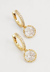 Gold hoop earrings with a sparkling clear gemstone drop. The hoop features a row of small clear stones along the edge.