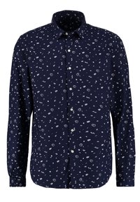 Námořnicky modrá košile s dlouhým rukávem a bílými rozptýlenými vzory různých tvarů. Má klasický límec a knoflíky na přední straně. Bavlněná tkanina.