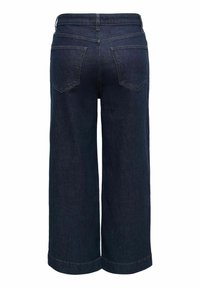 Jean denim bleu foncé à jambes larges, vu de dos, avec deux poches arrière et des ourlets cousus.