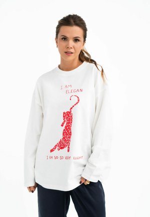 Witte sweatshirt met lange mouwen met een rode gestippelde kattenafbeelding en de tekst "IK BEN ELEGANT" en "IK BEN ZO ZO HEEL ELEGANT" in het rood.