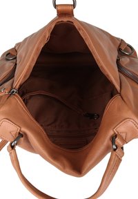 Sac à main en cuir marron ouvert montrant l'intérieur vide avec poche zippée et petite attache pour bandoulière à l'intérieur.