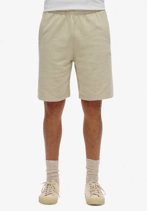 Beige shorts lavet af tekstureret stof, med elastisk talje, sidelommer og et lille broderet logo foran.