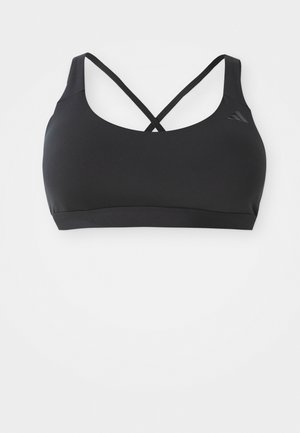 Sutien sport negru, fabricat dintr-un material neted și elastic, cu un design tip cruce pe spate, bretele largi și un mic logo pe partea stângă.