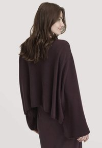 Lila �übergroße Poncho, weiche Textur, fließendes Design, weite Ärmel und ein leicht verkürzter Rücken. Geeignet zum Layering über Outfits.