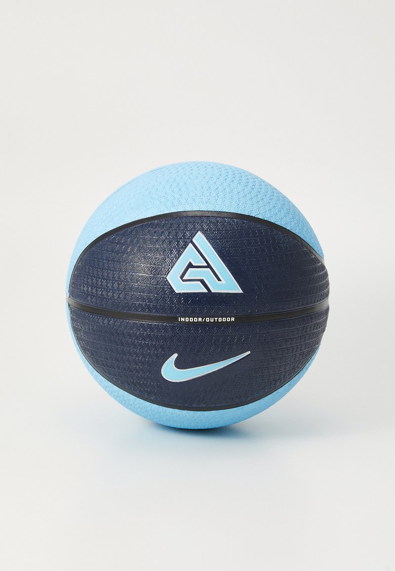 Basketbal s textúrovaným povrchom, tmavomodrou a svetlomodrou farebnou schémou, obsahujúci logá a nápis "VNÚTRI/NA OBCI" vytlačený na strane.