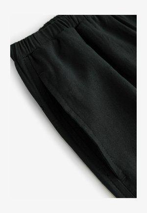 Sorte bomulds shorts med elastisk talje og sideslidser. Har en glat tekstur og foldede kanter for holdbarhed.