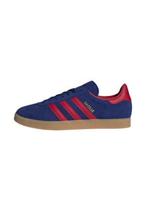 Blue suede Adidas Gazelle sneaker with red stripes and heel tab, beige sole, side logo in gold lettering.