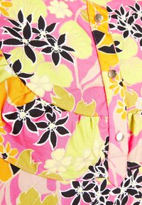 Floral dress fabric featuring pink, yellow, and green hues, with black accents. Ruffle detail and gold buttons along the front placket.