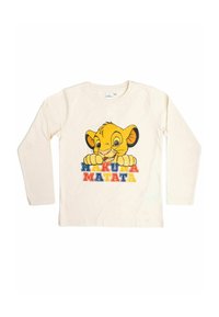 Camicia a maniche lunghe color crema con il volto di un leone cartone giallo e la scritta "HAKUNA MATATA" in lettere multicolori sottostante. Tessuto di cotone morbido.