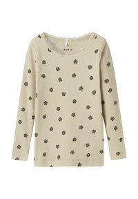 Lichtbeige langarmshirt met ribbelstructuur, voorzien van kleine bruine bloemmotieven en een ronde hals met kantafwerking.