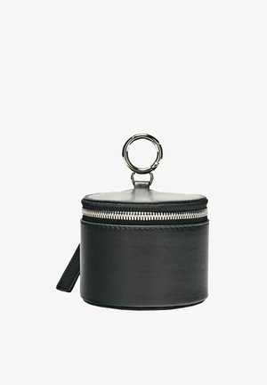 Black cylindrical leather pouch with silver zipper and large silver keyring attached on top against white background.
