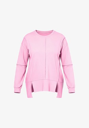 Růžová mikina s dlouhými rukávy, volným střihem, bočními rozparky a kulatým výstřihem. Vyrobena z měkké látky s viditelným švem.