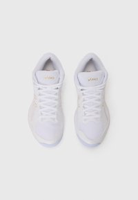 White athletic shoes with mesh and synthetic materials. Features include gold logo, woven laces, padded collar, and textured soles.