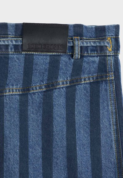 Blue denim fabric with dark vertical stripes, yellow stitching, a belt loop, and a black leather label reading "BOBO CHOSES" on the waistband.