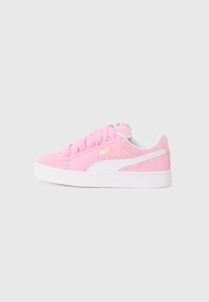 Pink suede sneaker with white accents, rounded toe, thick white sole, and prominent lacing, featuring a small logo on the side.