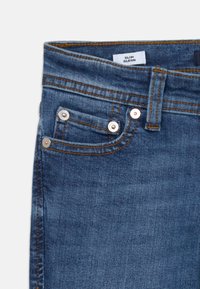 Slim-fit dark blue denim jeans with a smooth texture, contrasting orange stitching, and silver hardware on the pockets.