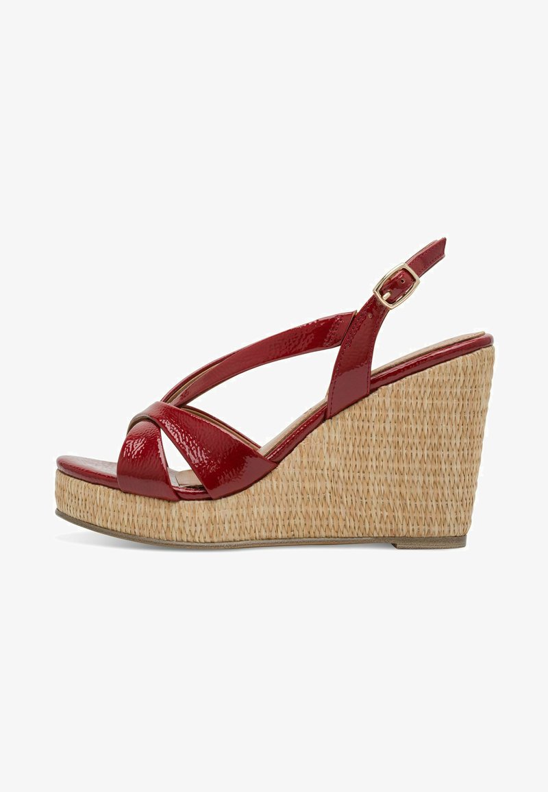 Sandales compensées en cuir verni rouge avec une base à texture de paille, dotées de brides croisées et d'une boucle réglable à la cheville pour un maintien sécurisé.