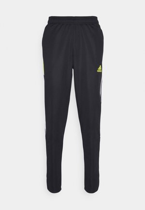Pantalon de sport noir Adidas avec taille élastique, jambes fuselées, bandes blanches sur les côtés et logo Adidas jaune fluo sur la cuisse droite.
