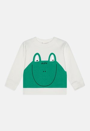 Sweat-shirt blanc avec un motif de grenouille verte aux grands yeux et à la bouche souriante, en tissu doux avec manches à bords-côtes.