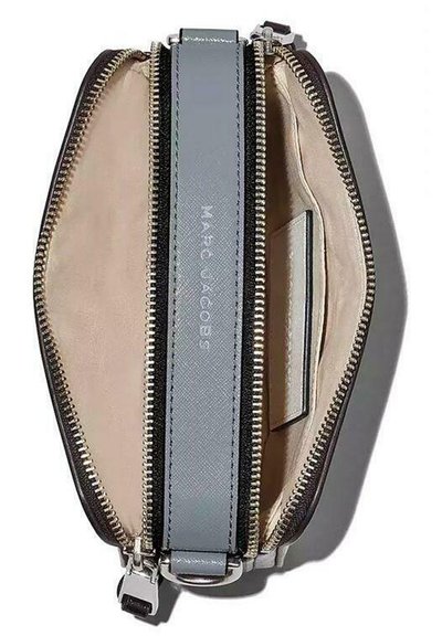 Gray leather wallet with a zip closure, beige interior, silver hardware, and a card slot. Features a smooth texture and sleek design.