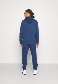 Reebok PIPING JOGGER - Calças de fato de treino - batik blue