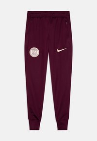 I pantaloni sportivi Nike color bordeaux presentano un design affusolato, una cintura elastica, tasche laterali e un logo di Parigi ricamato sulla coscia sinistra.