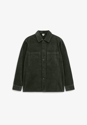 Dark green corduroy shirt with a button-up front, collar, and two chest pockets. The fabric features vertical ridges and a soft texture.
