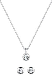 Collana in argento con ciondolo rotondo dotato di pietra preziosa trasparente, accompagnata da orecchini abbinati con un design simile della pietra.