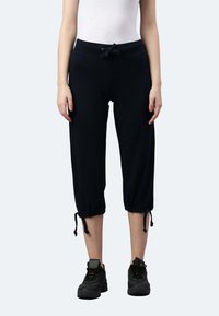 Pantaloni da jogging neri a vita corta realizzati in tessuto morbido, con cintura elastica, coulisse e lacci regolabili all'orlo.