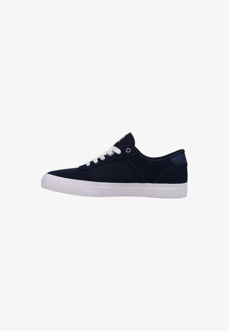 Navy blue canvas sneakers with white rubber sole, round toe, and white laces. Features a smooth texture and minimal design.