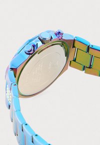 Reloj cronógrafo con un acabado metálico en tonos del arcoíris, que presenta una caja texturizada, tres pulsadores y un fondo de metal pulido.
