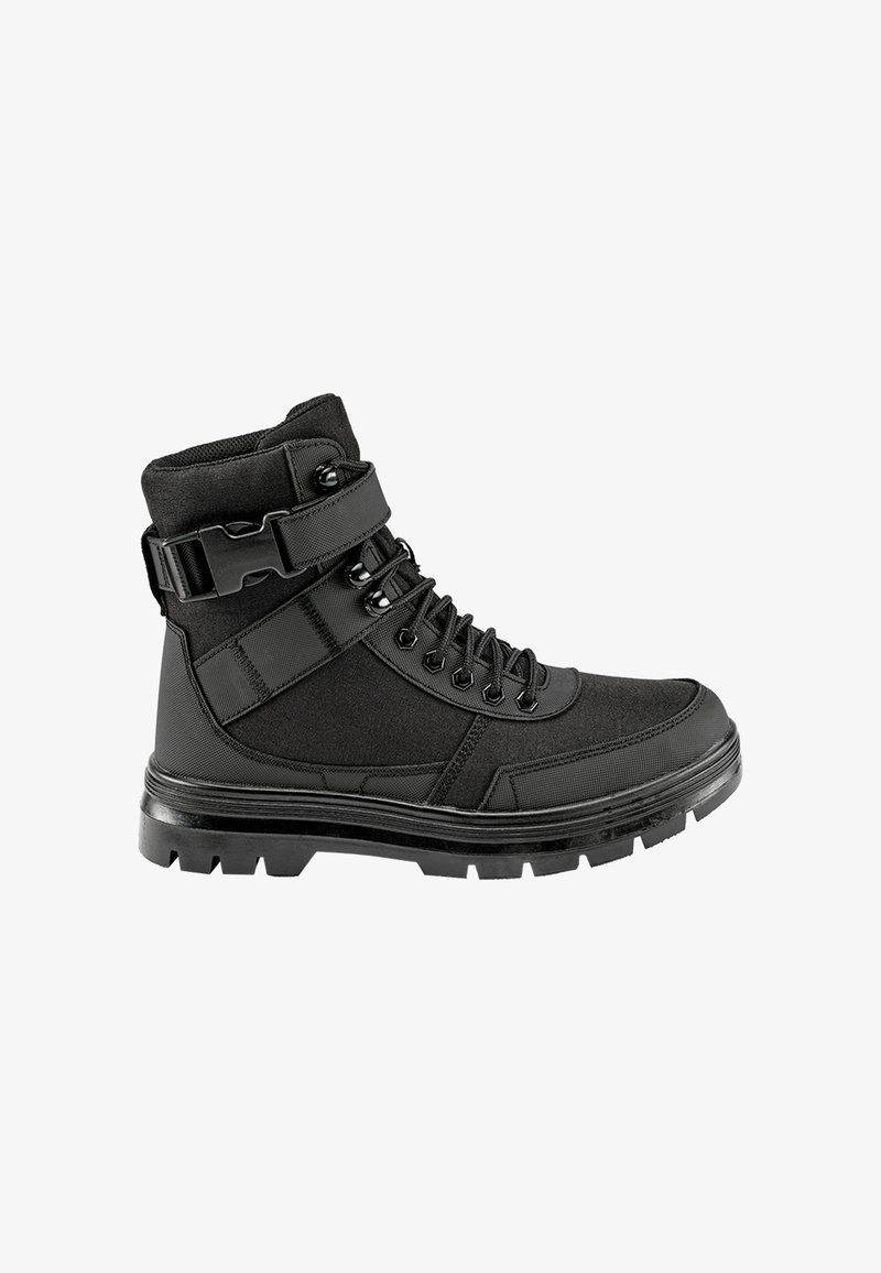 Botte tactique noire avec semelle épaisse, devant lacé et sangle réglable avec boucle autour de la cheville.