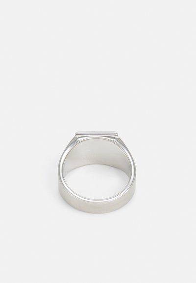 Metal ring with smooth, polished silver finish. Rounded band and flat top with slight ridge detail. Simple, minimalist design.