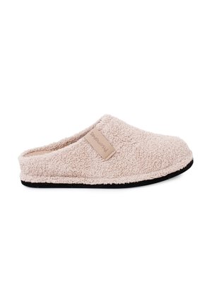 Beige, fuzzy slip-on slipper with black sole and a small rectangular tag on the side, designed for indoor use.