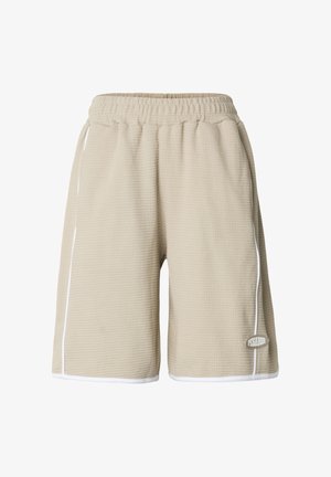 Beigen värisiä, vohvelipintaisten shortsien vyötäröllä on joustava nauha, valkoiset sivusaumat ja etuosan vasemmassa alareunassa pieni brändilogokuva.