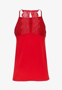 Červený bezrukávový top s krajkovým zadním dílem a výstřihem. Vyrobený z hladkého materiálu s jemnou texturou, má nastavitelná ramínka a přiléhavý střih.