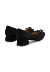 Scarpe basse nere in suede con punta arrotondata, dotate di decorazioni decorative sulla parte anteriore e una superficie esterna testurizzata.