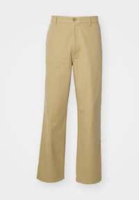 Beige, wide-leg trousers made of cotton. Features a front button closure and stitched hem. Smooth texture with no patterns or accents.