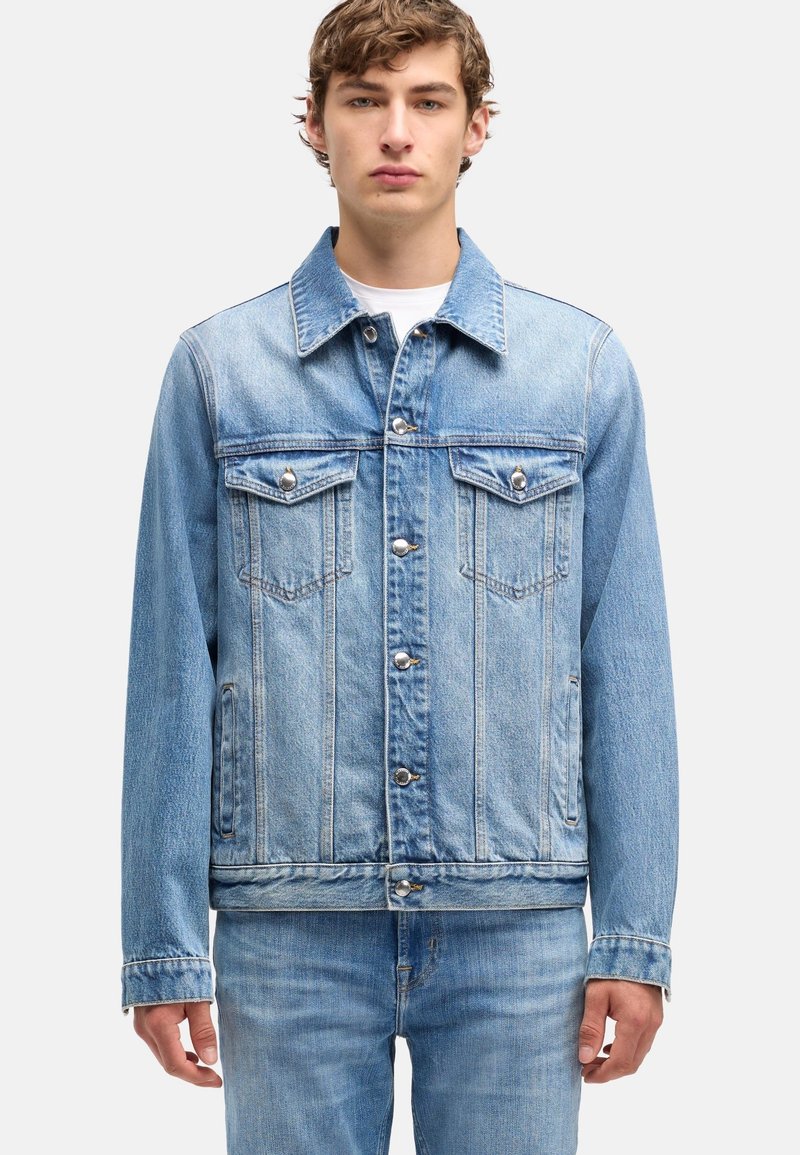Lichtblauwe spijkerjas met kraag, knoopsluiting aan de voorkant en twee borstzakken. Versleten textuur en klassiek truckerontwerp.