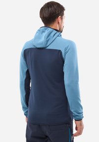 Hooded sweatshirt featuring a two-tone design, light blue front and dark blue back, textured fabric, and fitted sleeves.