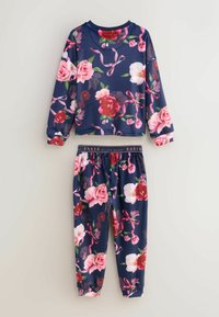 Navy floral pajama set featuring long-sleeve top and elastic-waist pants. Fabric adorned with pink and red roses, with a soft texture.