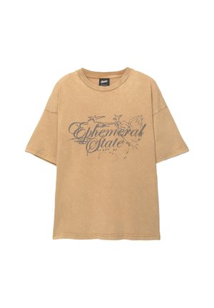 T-shirt brun surdimensionné en coton, avec un imprimé graphique portant la mention "État Éphémère" et des motifs d'étoiles dans des tons plus sombres. Encolure en crew.