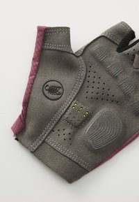 Bezprstové rukavice vyrobené z šedé semišové látky s růžovými akcenty. Design zahrnuje texturované plochy pro uchopení a perforace pro ventilaci.