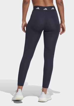 Navy hoge taille leggings van een gladde, rekbare stof, met een brede tailleband met drie witte strepen en naaddetails.