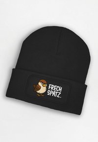Black knit beanie featuring an embroidered patch with a cartoon sparrow and the text "FRECH SPATZ." Beanie has textured fabric.