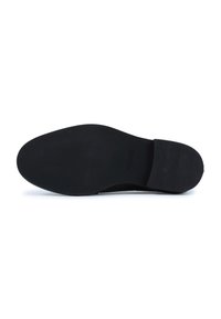 Black shoe sole with a smooth, flat surface. Features subtle ridges near the heel and a clean, edge finish. No visible logos or patterns.