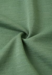 Grüner gestrickter Stoff mit einer glatten Textur, der ein gleichmäßiges Rippmuster und einen weichen Fall zeigt, geeignet für Bekleidung oder Textilien.