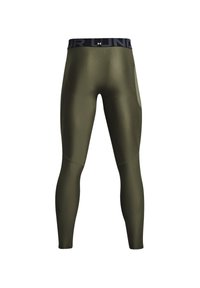 Olijfgroene legging met een zwarte elastische tailleband. Gladde textuur, aansluitend ontwerp en zijzak voor gemak.