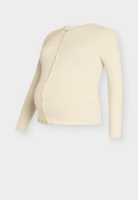 Cream-colored maternity cardigan, long-sleeved with a round neck, front button closure, and soft, textured knit fabric.